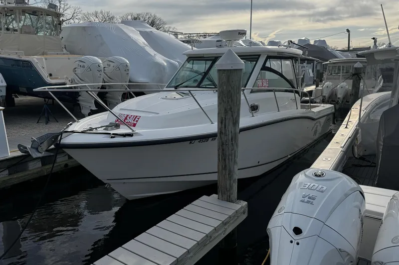 Slide: The Image of 2016 Boston Whaler 315 Conquest boat for sale at marina dock. - 3
