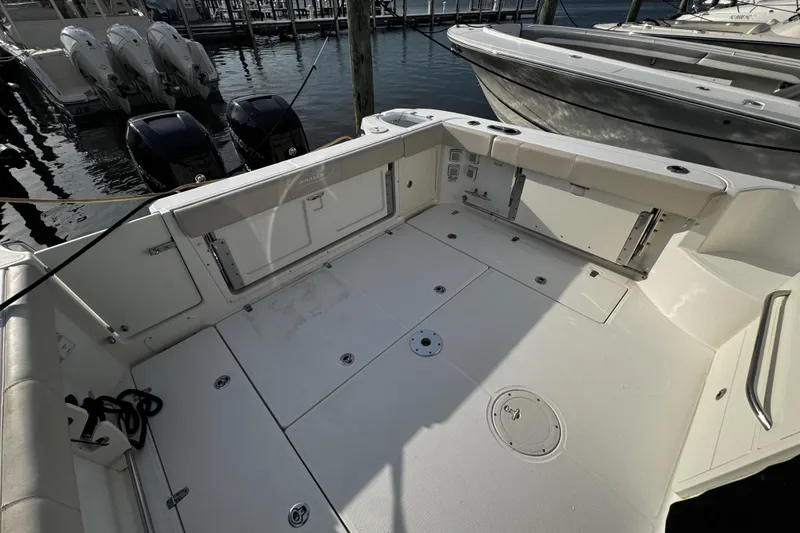 Slide: The Image of 2016 Boston Whaler 315 Conquest boat deck with outboard motors at marina. - 30