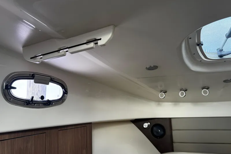 Slide: The Image of Interior cabin view of 2016 Boston Whaler 315 Conquest with porthole and ceiling lights. - 33