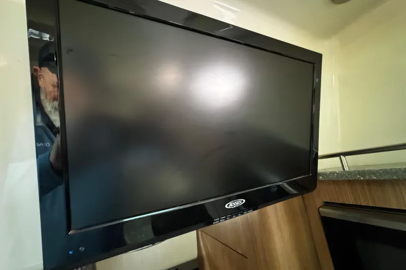 Slide: The Image of Flat-screen TV inside 2016 Boston Whaler 315 Conquest boat cabin. - 34