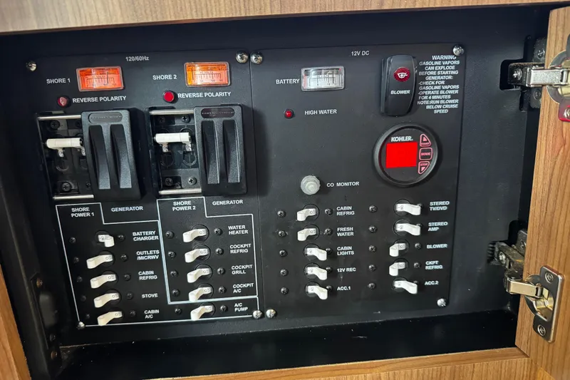 Slide: The Image of Electrical control panel of a 2016 Boston Whaler 315 Conquest boat, featuring switches and indicators. - 36