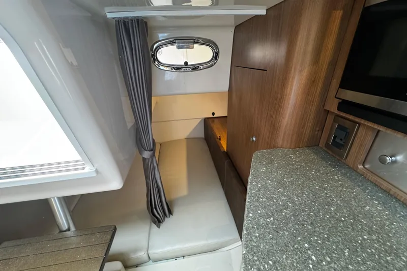Slide: The Image of Interior cabin of 2016 Boston Whaler 315 Conquest with seating and wood cabinetry. - 44
