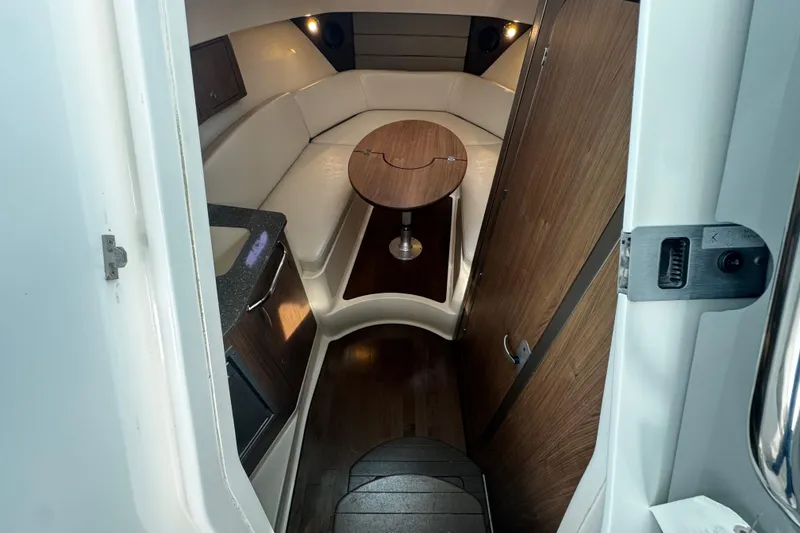 Slide: The Image of 2016 Boston Whaler 315 Conquest cabin interior with seating and table. - 46