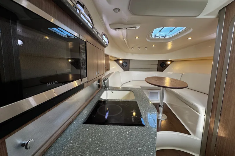 Slide: The Image of Luxurious interior of 2016 Boston Whaler 315 Conquest with modern kitchen and seating area. - 48