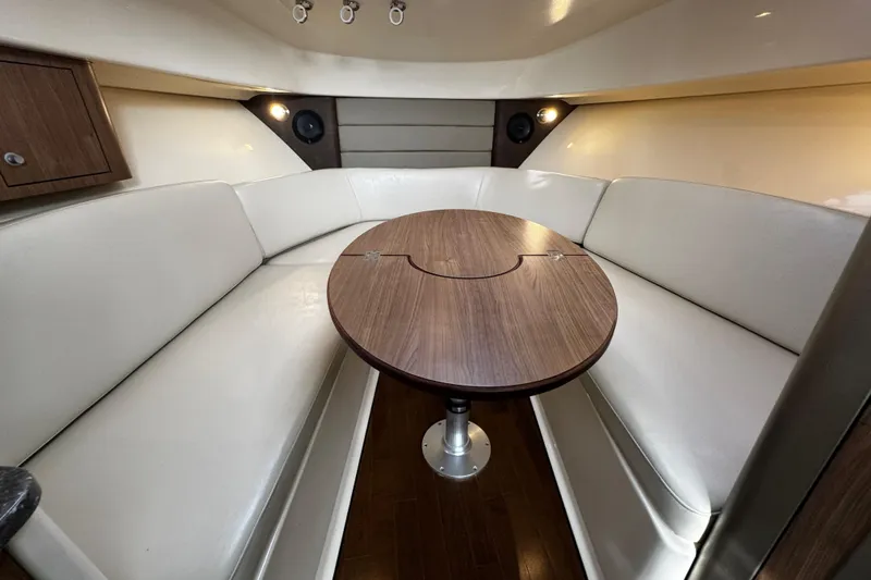 Slide: The Image of Interior of 2016 Boston Whaler 315 Conquest with elegant seating and wooden table. - 49
