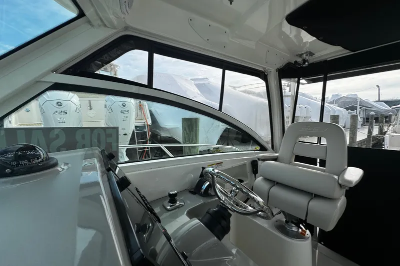 Slide: The Image of Interior view of 2016 Boston Whaler 315 Conquest boat cockpit with helm and seating. - 58