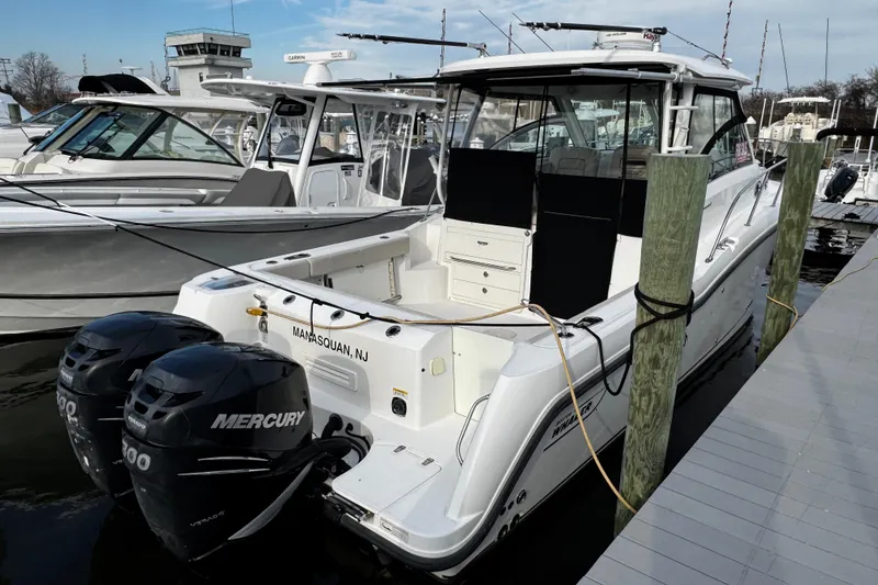 Slide: The Image of 2016 Boston Whaler 315 Conquest docked with twin Mercury engines. - 6