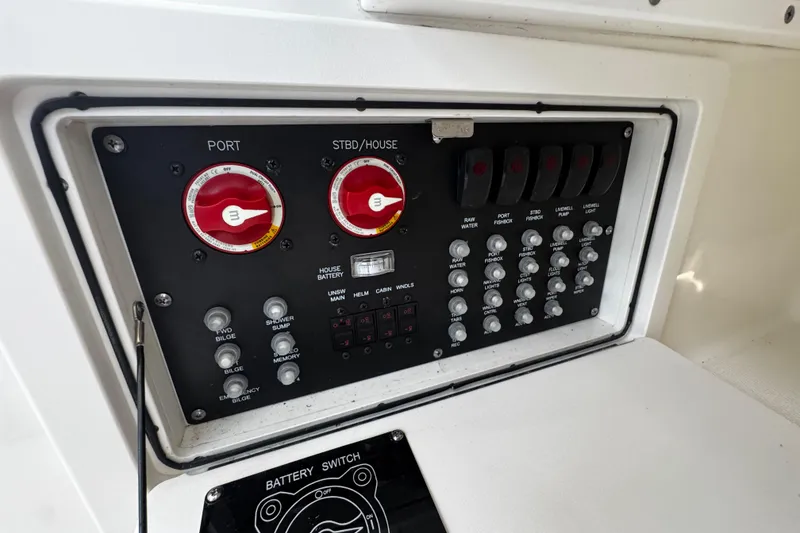 Slide: The Image of Control panel of a 2016 Boston Whaler 315 Conquest boat with switches and dials. - 60