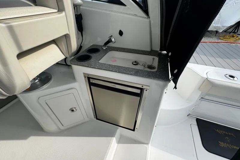 Slide: The Image of 2016 Boston Whaler 315 Conquest interior with sink and mini fridge. - 65