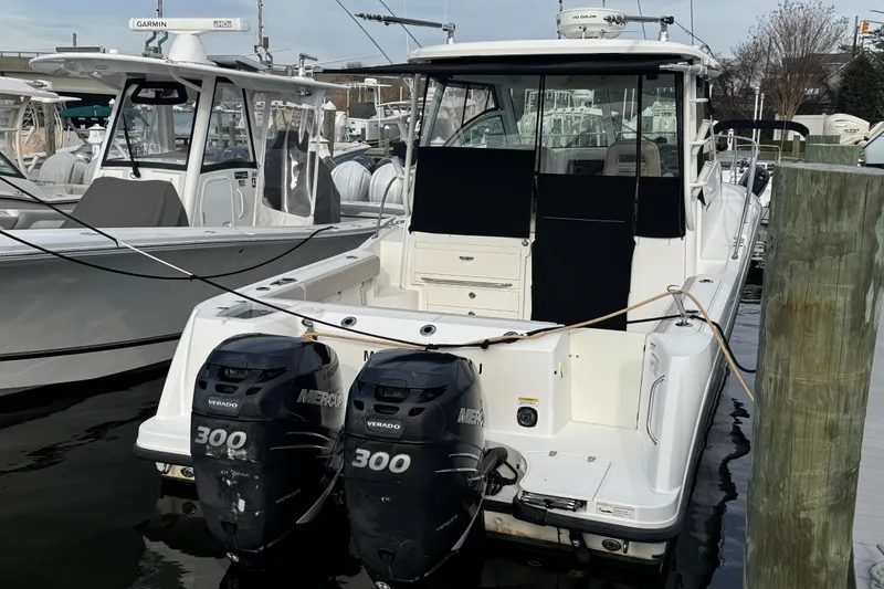 Slide: The Image of 2016 Boston Whaler 315 Conquest boat with twin Mercury 300 engines docked at marina. - 7