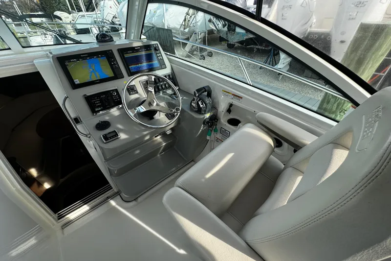 Slide: The Image of 2016 Boston Whaler 315 Conquest helm with modern navigation displays and comfortable seating. - 71