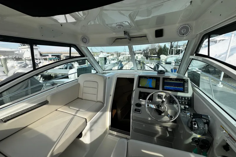 Slide: The Image of Interior of 2016 Boston Whaler 315 Conquest boat with modern navigation equipment and seating. - 72