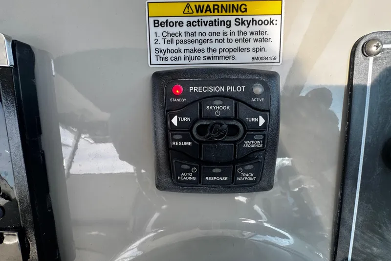 Slide: The Image of Control panel of a 2016 Boston Whaler 315 Conquest boat with Skyhook feature. - 79