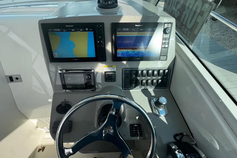 Slide: The Image of Helm of 2016 Boston Whaler 315 Conquest with navigation displays and controls. - 83