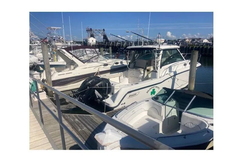 Slide: The Image of 2016 Boston Whaler 315 Conquest docked at marina under clear blue sky. - 84