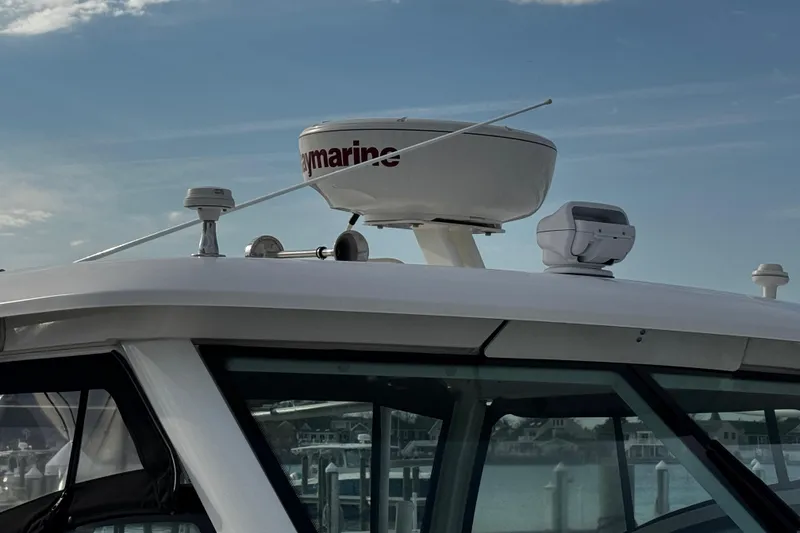Slide: The Image of 2016 Boston Whaler 315 Conquest boat with radar and navigation equipment on the roof. - 9