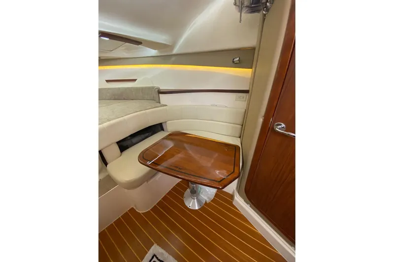 Slide: The Image of 2021 Grady-White Express 330 cabin interior with wooden table and seating area. - 19
