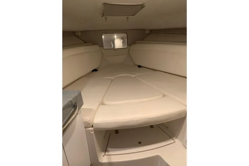 Slide: The Image of 2021 Grady-White Express 330 cabin interior with beige seating and compact design. - 20