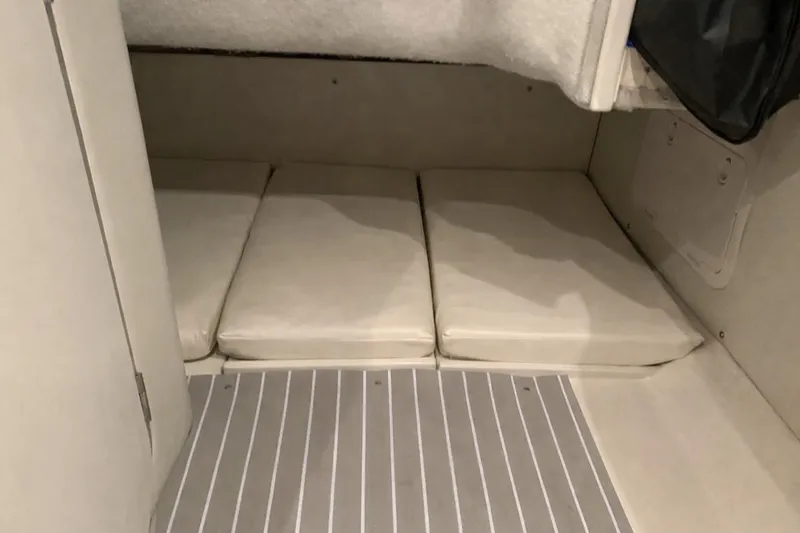 Slide: The Image of 2021 Grady-White Express 330 cabin interior with cushioned seating and striped flooring. - 23