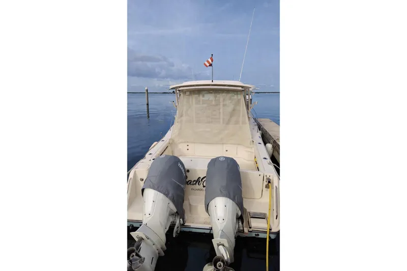 Slide: The Image of 2021 Grady-White Express 330 boat docked with twin outboard motors. - 27