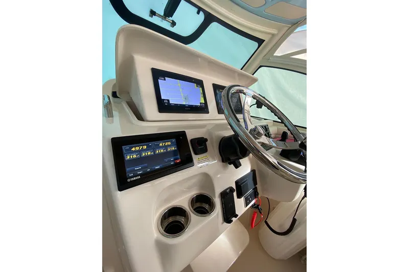 Slide: The Image of 2021 Grady-White Express 330 helm with advanced navigation and control displays. - 8