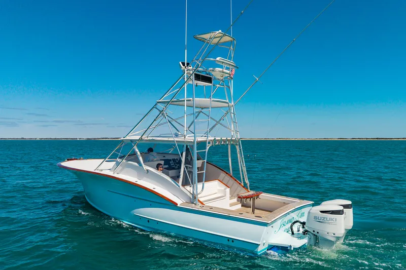 Slide: The Image of 2009 Custom Carolina 36 Express boat on open sea. - 10