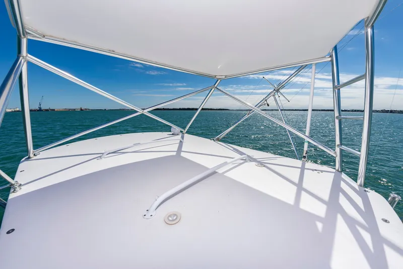 Slide: The Image of 2009 Custom Carolina 36 Express on open water under clear sky. - 23