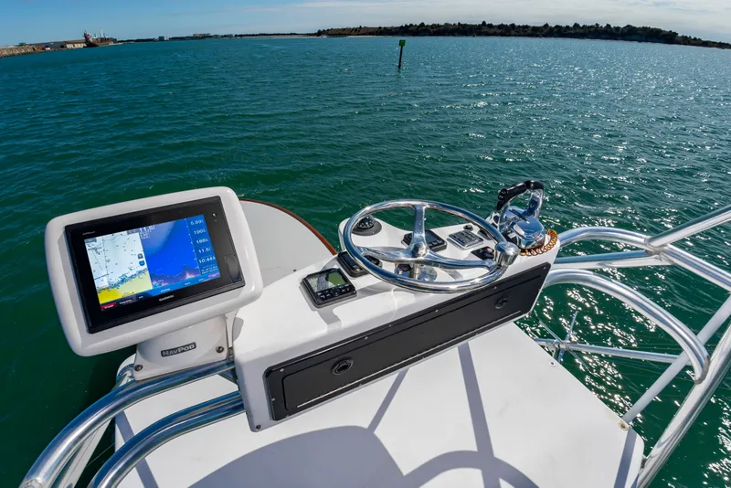 Slide: The Image of Helm of 2009 Custom Carolina 36 Express on open water. - 26