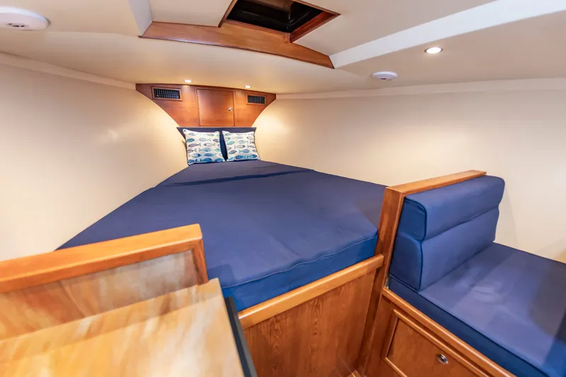 Slide: The Image of Interior of 2009 Custom Carolina 36 Express with blue bedding. - 31