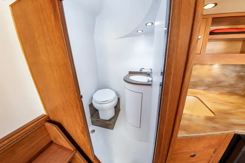 Slide: The Image of Interior of 2009 Custom Carolina 36 Express with bathroom and wood finish. - 32