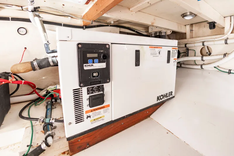 Slide: The Image of Kohler generator in engine room of 2009 Custom Carolina 36 Express. - 34