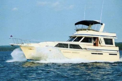The Image of 1985 Chris Craft 500 yacht cruising on open water under clear skies. - 0
