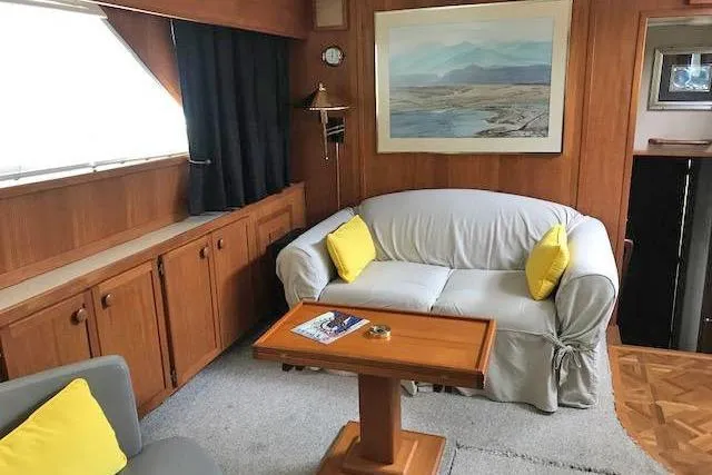 Slide: The Image of Interior of 1985 Chris Craft 500 yacht with cozy seating and nautical decor. - 14