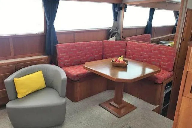 Slide: The Image of Interior of 1985 Chris Craft 500 yacht with red seating and wooden table. - 15