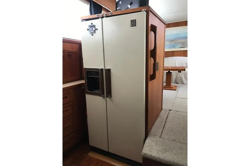 Slide: The Image of 1985 Chris Craft 500 yacht interior with vintage refrigerator and wooden cabinetry. - 18