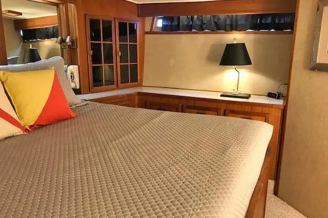 Slide: The Image of Luxurious bedroom interior of 1985 Chris Craft 500 yacht with cozy bedding and elegant lighting. - 20