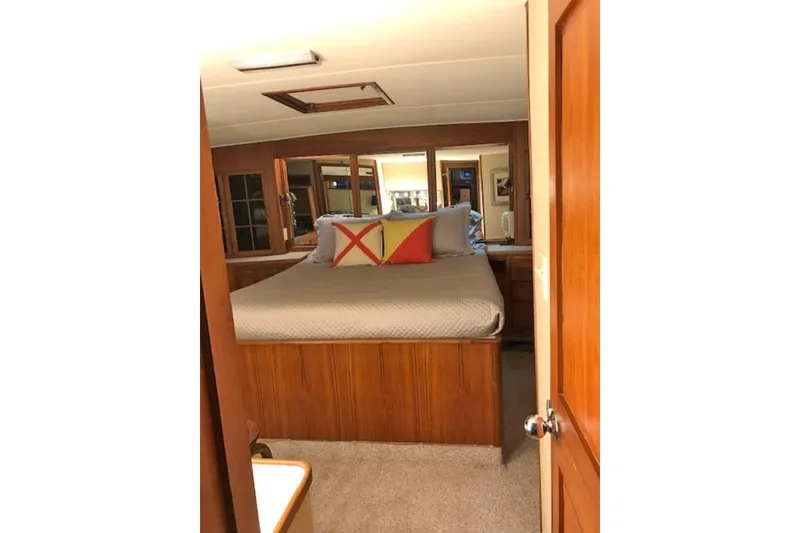 Slide: The Image of 1985 Chris Craft 500 yacht bedroom with wooden decor and cozy bedding. - 21