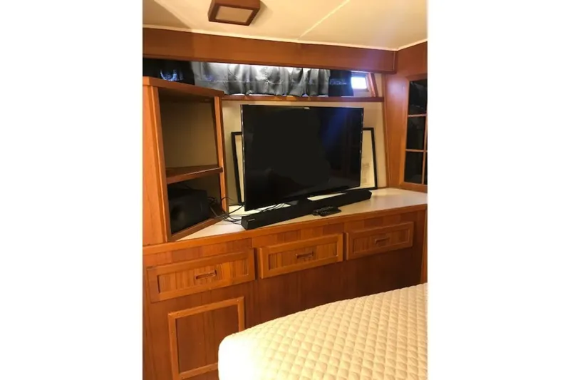 Slide: The Image of 1985 Chris Craft 500 interior with TV and wooden cabinetry. - 22