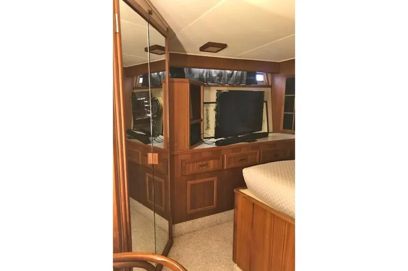 Slide: The Image of 1985 Chris Craft 500 yacht interior with wood cabinetry and a mounted TV. - 23