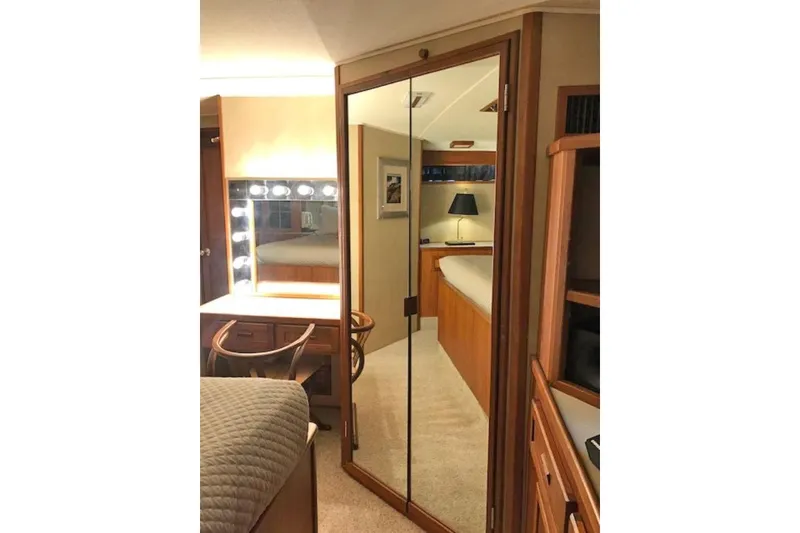 Slide: The Image of Luxurious 1985 Chris Craft 500 yacht interior with mirrored closet and vanity area. - 24