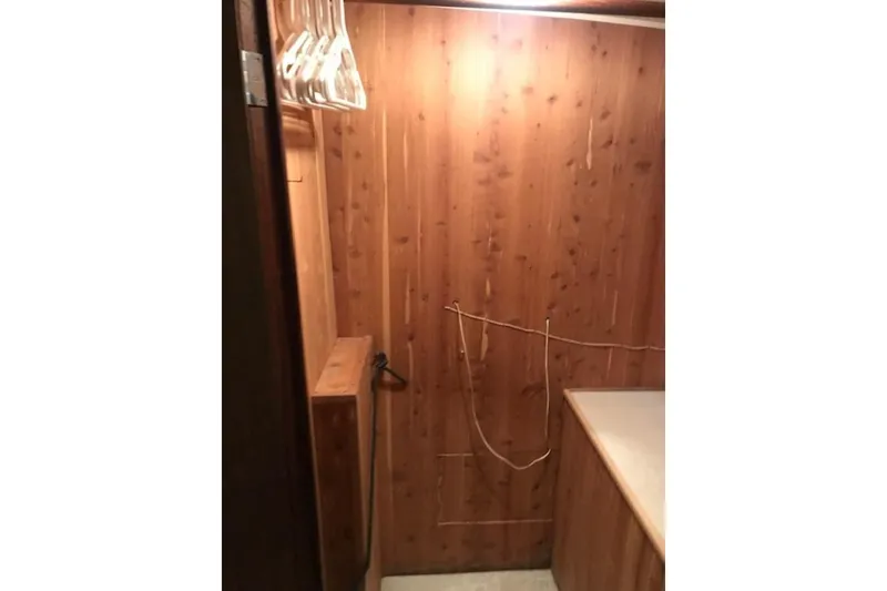 Slide: The Image of Wood-paneled interior of 1985 Chris Craft 500 yacht with hangers and countertop. - 25