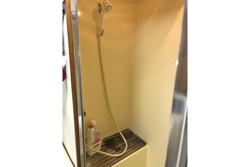 Slide: The Image of Shower area inside a 1985 Chris Craft 500 yacht, featuring a handheld showerhead. - 28