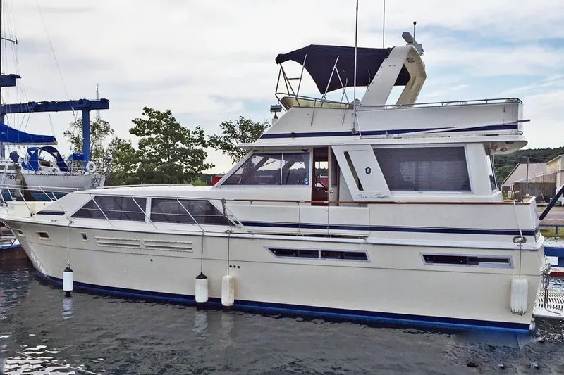 Slide: The Image of 1985 Chris-Craft 500 Constellation yacht docked in a marina, side view. - 3
