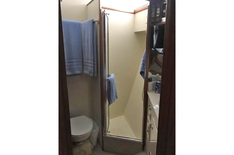 Slide: The Image of Bathroom interior of 1985 Chris Craft 500 yacht with shower and blue towels. - 33