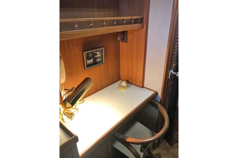 Slide: The Image of 1985 Chris Craft 500 yacht interior with wooden desk and decorative elements. - 35