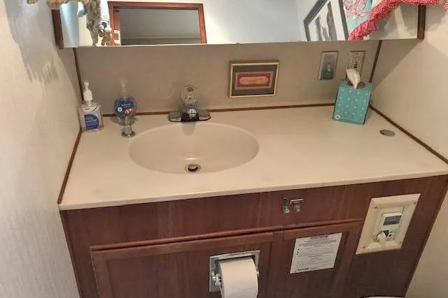 Slide: The Image of Bathroom vanity on a 1985 Chris Craft 500 yacht with sink and toiletries. - 38