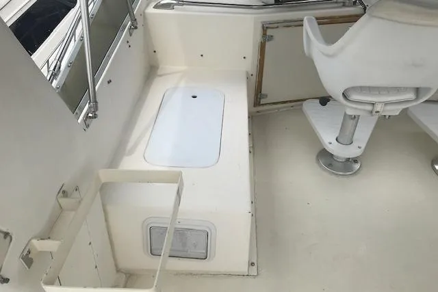 Slide: The Image of 1985 Chris Craft 500 boat interior with white seating and storage compartments. - 40