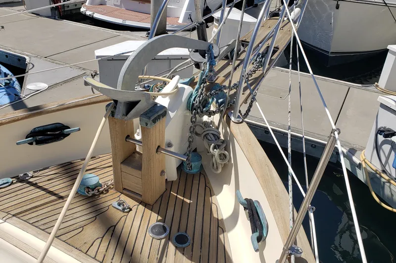Slide: The Image of 1987 Hans Christian 33 sailboat deck with anchor and rigging at marina. - 10