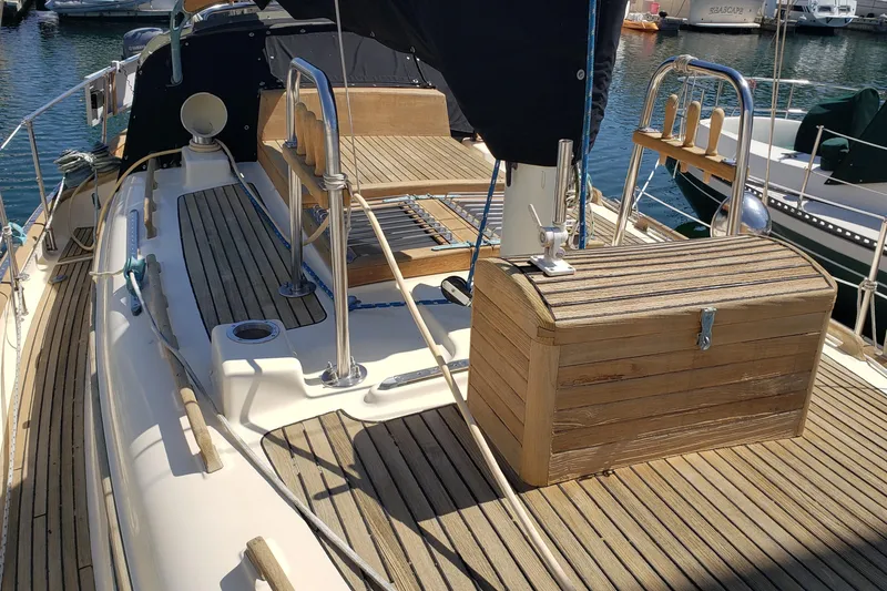 Slide: The Image of 1987 Hans Christian 33 sailboat deck with wooden fittings and nautical equipment. - 11