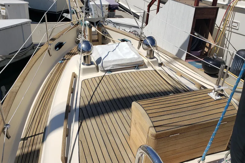 Slide: The Image of 1987 Hans Christian 33 sailboat deck with wooden finish and nautical equipment. - 13